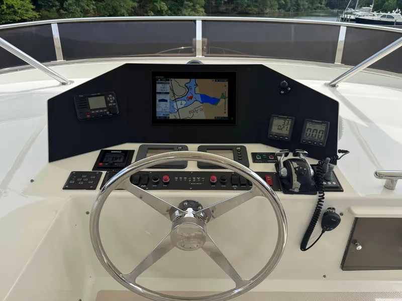 Slide: The Image of Helm of 2002 Marlow 70E yacht with navigation equipment and steering wheel. - 22