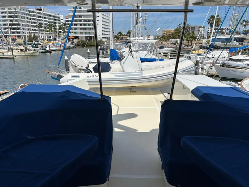 Slide: The Image of Marlow 70E yacht deck with covered seating, docked in a marina, 2002 model. - 27