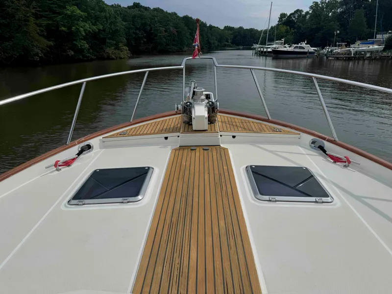 Slide: The Image of Bow view of 2002 Marlow 70E yacht on a calm river. - 29