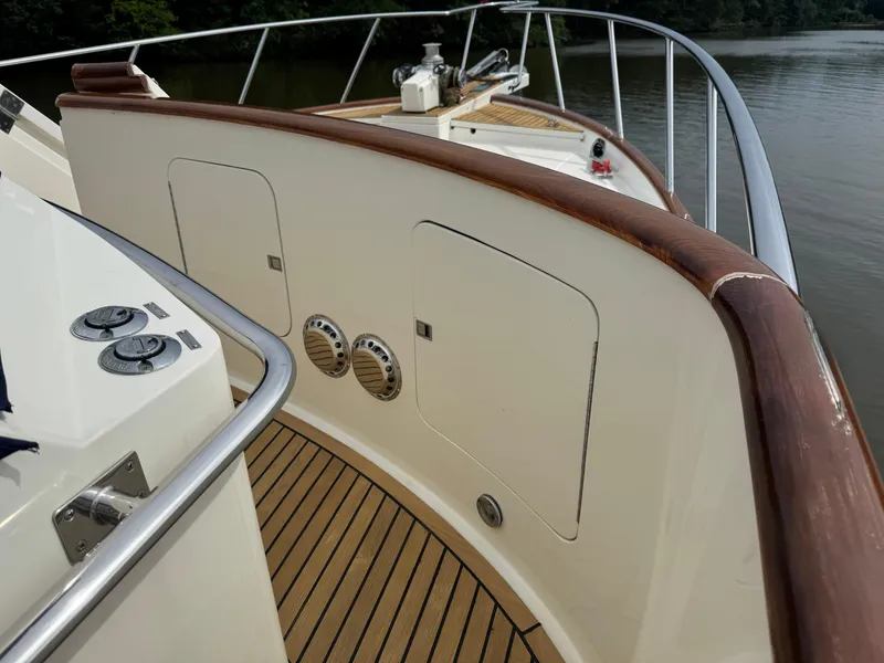 Slide: The Image of Deck view of 2002 Marlow 70E yacht with wooden railings and metal fixtures. - 31
