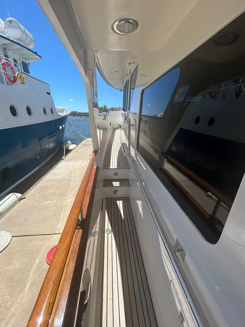 Slide: The Image of Side deck of a 2002 Marlow 70E yacht docked at a marina. - 36
