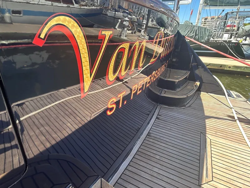 Slide: The Image of Luxury yacht "Van Dutch" docked, featuring sleek design and wooden deck. Marlow 70E, 2002 model. - 40