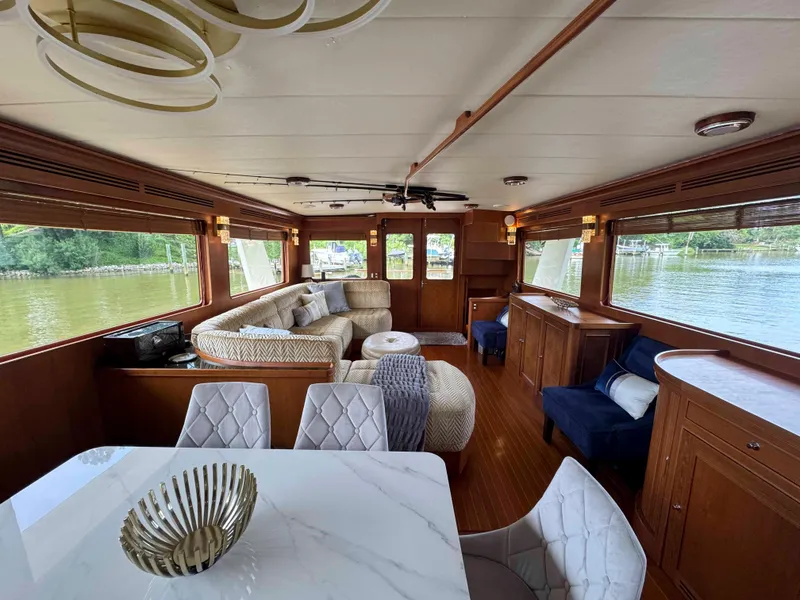 Slide: The Image of Luxurious interior of a 2002 Marlow 70E yacht with elegant furnishings and large windows. - 41