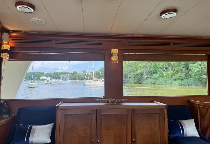 Slide: The Image of Interior view from a 2002 Marlow 70E yacht, overlooking a serene river and sailboats. - 45