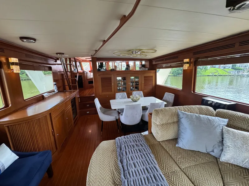 Slide: The Image of Luxurious interior of 2002 Marlow 70E yacht with elegant dining area and plush seating. - 48
