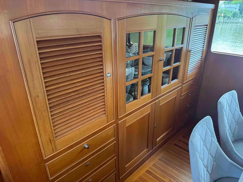 Slide: The Image of Wooden cabinetry with glass doors and drawers on a Marlow 70E yacht, 2002 model. - 50