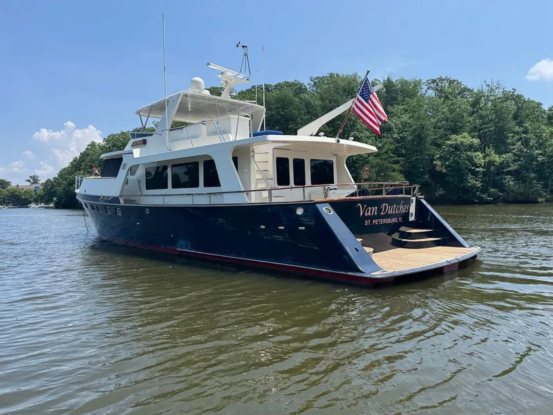 Slide: The Image of Luxury 2002 Marlow 70E yacht on a serene river, featuring an American flag. - 7