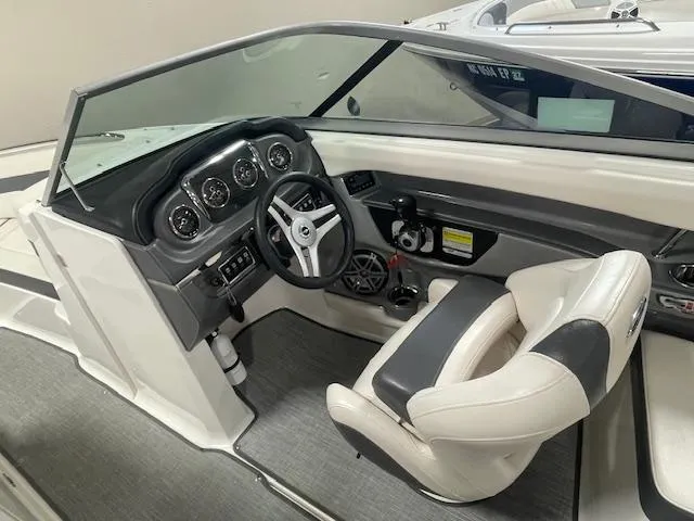 Slide: The Image of 2017 Chaparral 226 SSi boat interior with steering wheel and dashboard controls. - 10