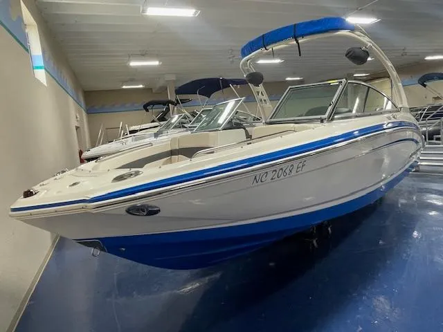 Slide: The Image of 2017 Chaparral 226 SSi boat with blue accents displayed indoors. - 2