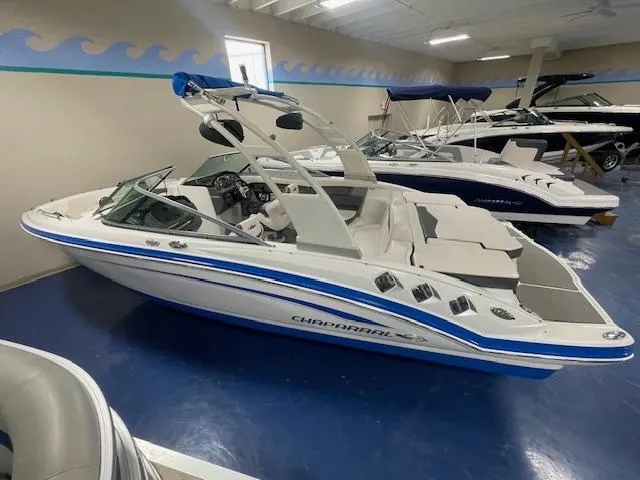 Slide: The Image of 2017 Chaparral 226 SSi boat in showroom, featuring sleek design and blue accents. - 3
