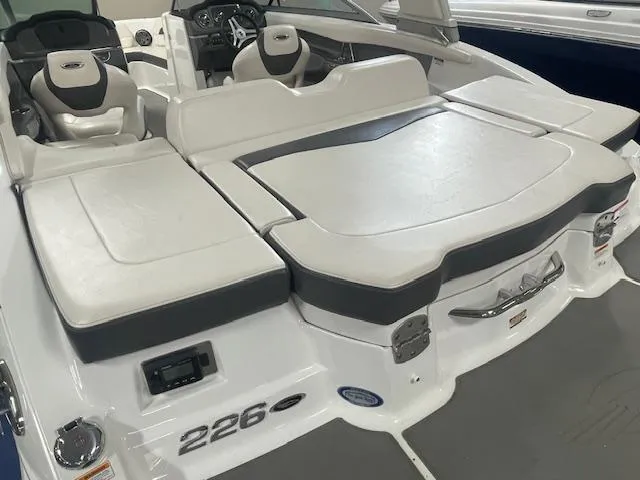 Slide: The Image of 2017 Chaparral 226 SSi boat interior with white and gray seating and dashboard. - 4