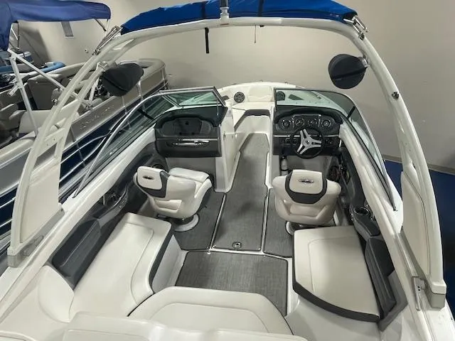 Slide: The Image of 2017 Chaparral 226 SSi boat interior with white seating and modern dashboard. - 5