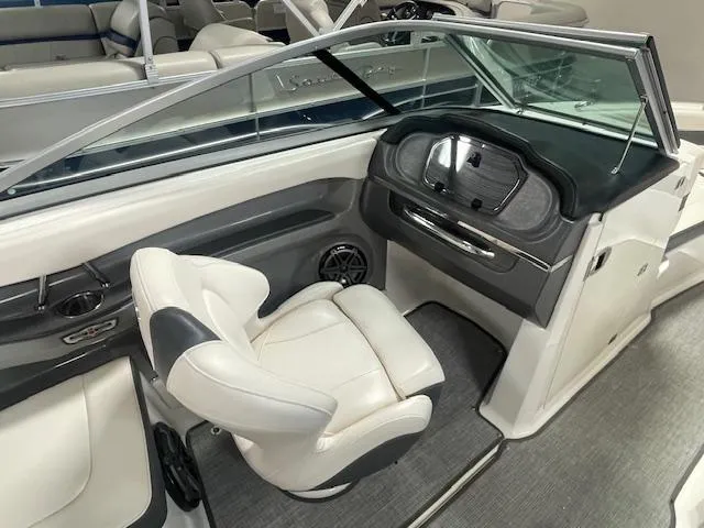 Slide: The Image of 2017 Chaparral 226 SSi boat interior with white captain's chair and dashboard. - 9