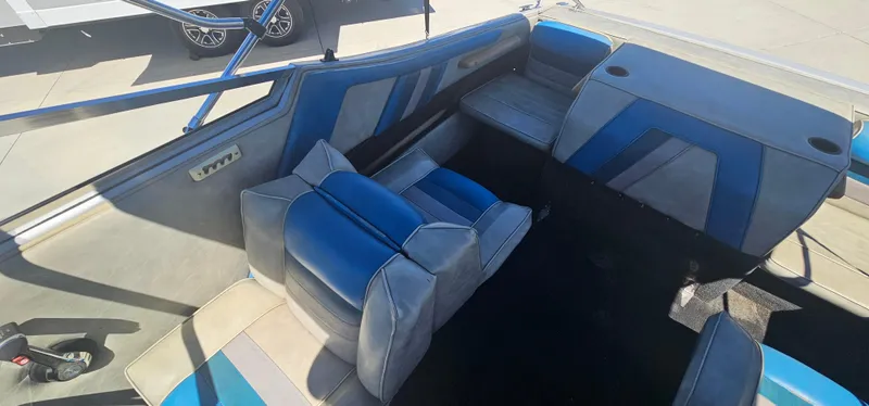 Slide: The Image of Interior of a 1989 Galaxie 1900 Starion boat with blue and gray seating. - 10