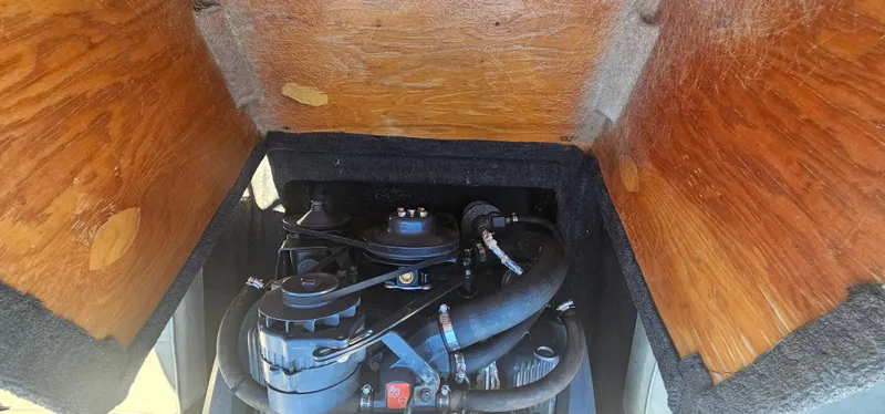 Slide: The Image of 1989 Galaxie 1900 Starion engine compartment with wooden cover and visible engine components. - 15