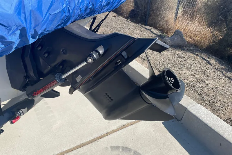 Slide: The Image of 1989 Galaxie 1900 Starion boat motor with blue cover, parked on concrete. - 17