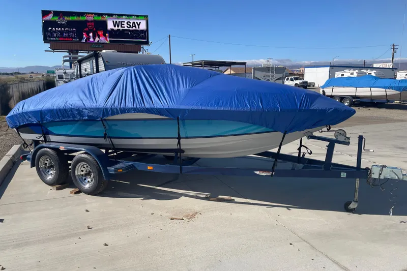 Slide: The Image of 1989 Galaxie 1900 Starion boat covered with blue tarp on trailer. - 5