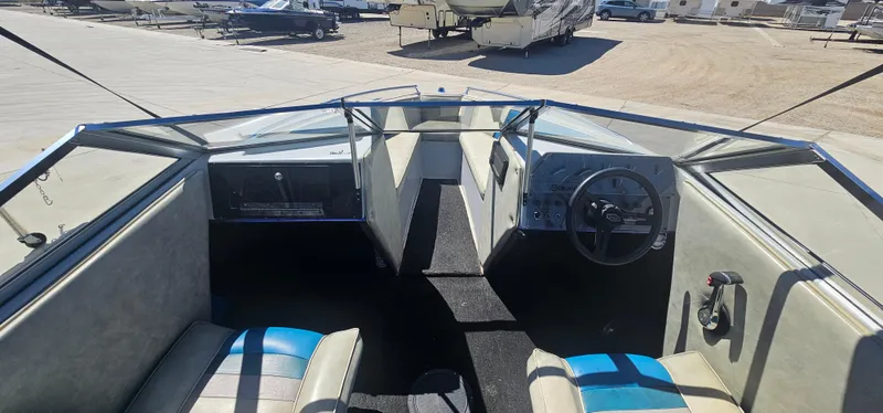 Slide: The Image of Interior of a 1989 Galaxie 1900 Starion boat, featuring steering wheel and seating. - 7