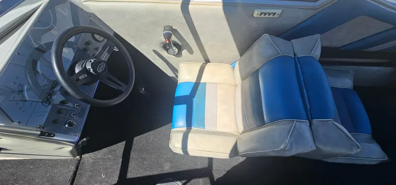 Slide: The Image of Interior of 1989 Galaxie 1900 Starion boat with blue and gray seating. - 9