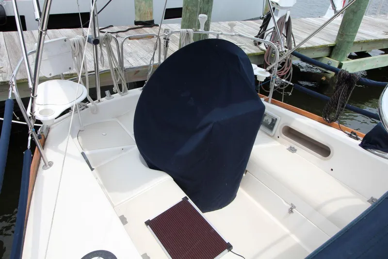 Slide: The Image of Cockpit of 1989 Pearson 39-2 sailboat docked, featuring covered steering wheel and seating area. - 10