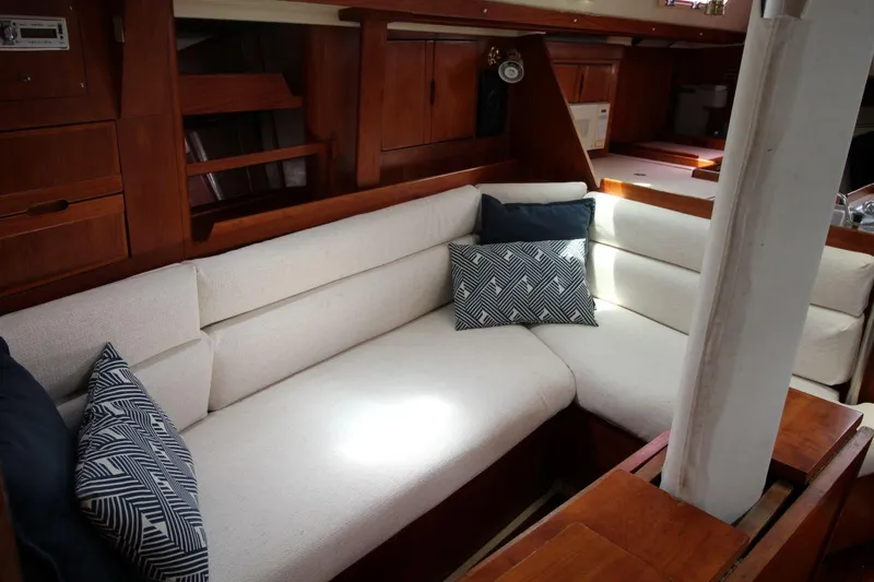 Slide: The Image of Cozy interior of 1989 Pearson 39-2 sailboat with cushioned seating and decorative pillows. - 18