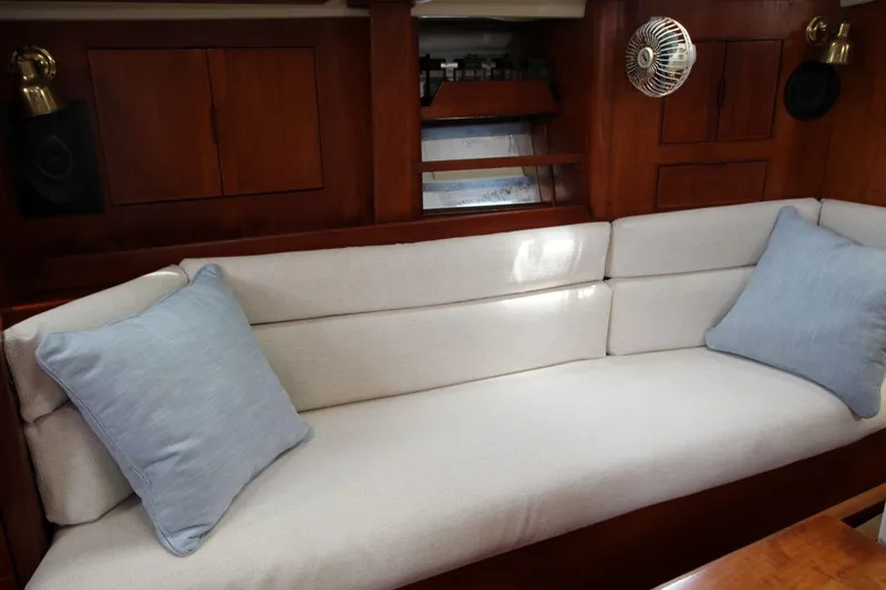 Slide: The Image of Cozy interior of 1989 Pearson 39-2 sailboat with cushioned seating and wooden cabinetry. - 19