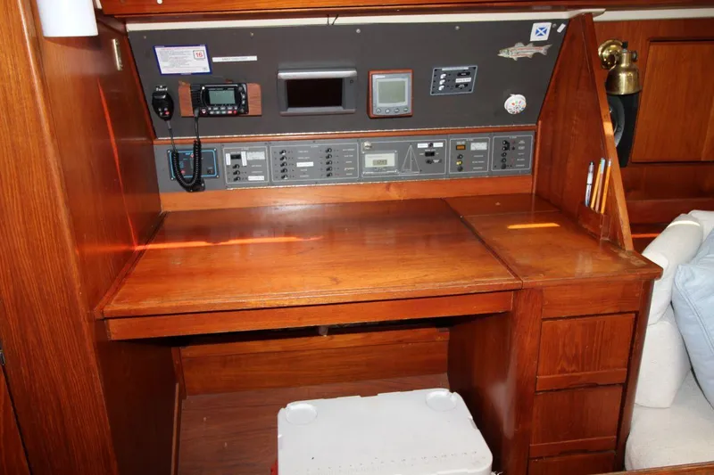 Slide: The Image of Navigation station on a 1989 Pearson 39-2 sailboat with control panels and wooden desk. - 20
