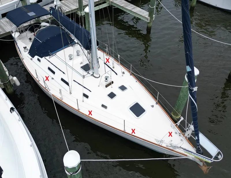 Slide: The Image of 1989 Pearson 39-2 sailboat docked, featuring a sleek design and blue canopy. - 25