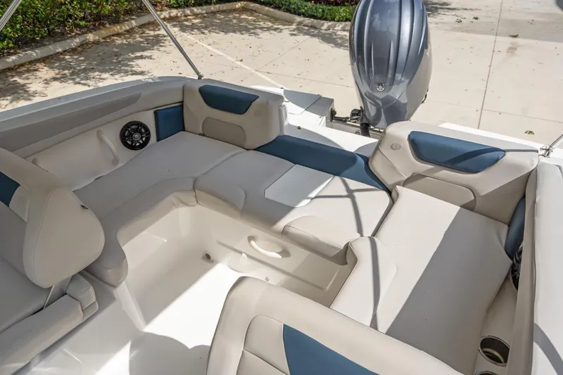 Slide: The Image of 2025 Hurricane SunDeck 2050 OB boat interior with cushioned seating and outboard motor. - 15