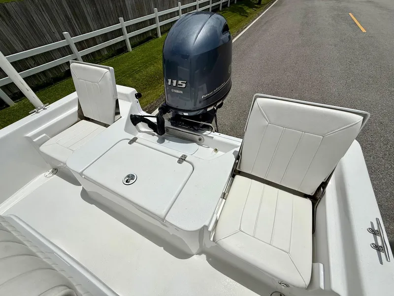 Slide: The Image of 2019 Blazer Bay 1900 boat with Yamaha 115 engine, white seating, and storage compartment. - 7