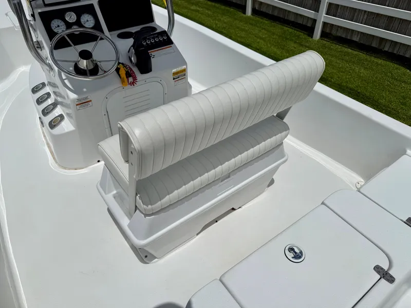 Slide: The Image of Interior of 2019 Blazer Bay 1900 boat with white seating and steering console. - 9