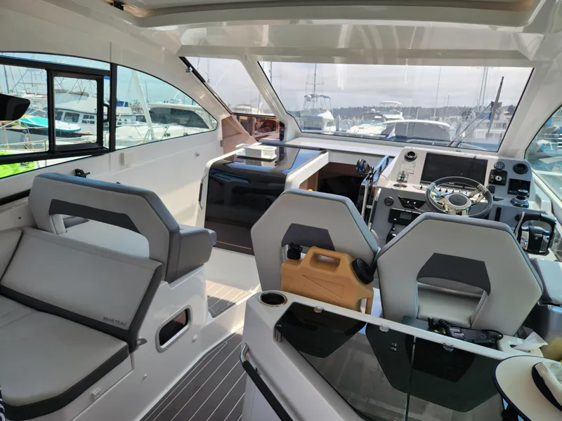Slide: The Image of Interior of 2023 Beneteau GT32 yacht, featuring modern helm and seating area. - 13