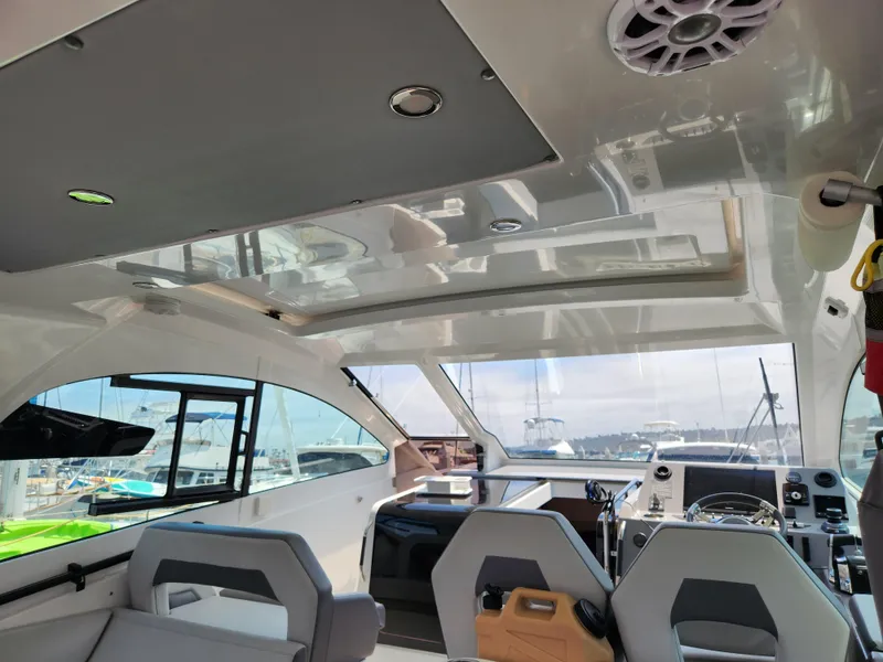 Slide: The Image of Interior view of 2023 Beneteau GT32 yacht, featuring modern seating and navigation equipment. - 14