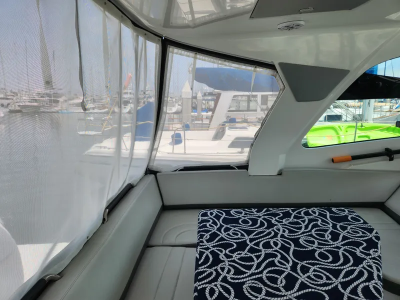 Slide: The Image of Interior view of 2023 Beneteau GT32 yacht with marina backdrop. - 15