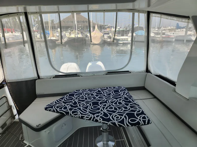 Slide: The Image of Interior of 2023 Beneteau GT32 yacht with marina view through windows. - 17
