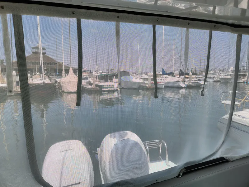 Slide: The Image of 2023 Beneteau GT32 view from cabin, overlooking marina with multiple boats docked. - 18