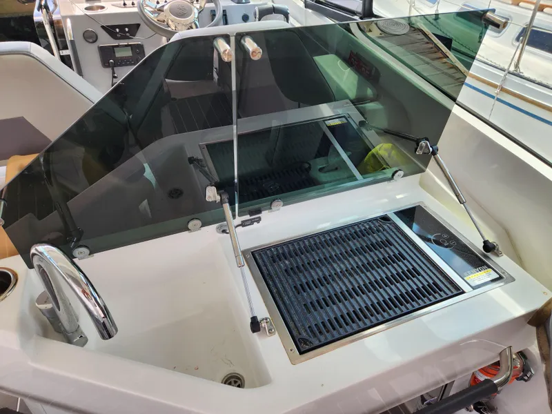 Slide: The Image of 2023 Beneteau GT32 boat interior with grill and sink setup. - 21