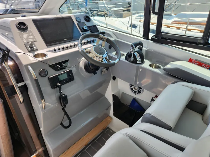 Slide: The Image of Cockpit of 2023 Beneteau GT32 boat with modern steering and control panel. - 22