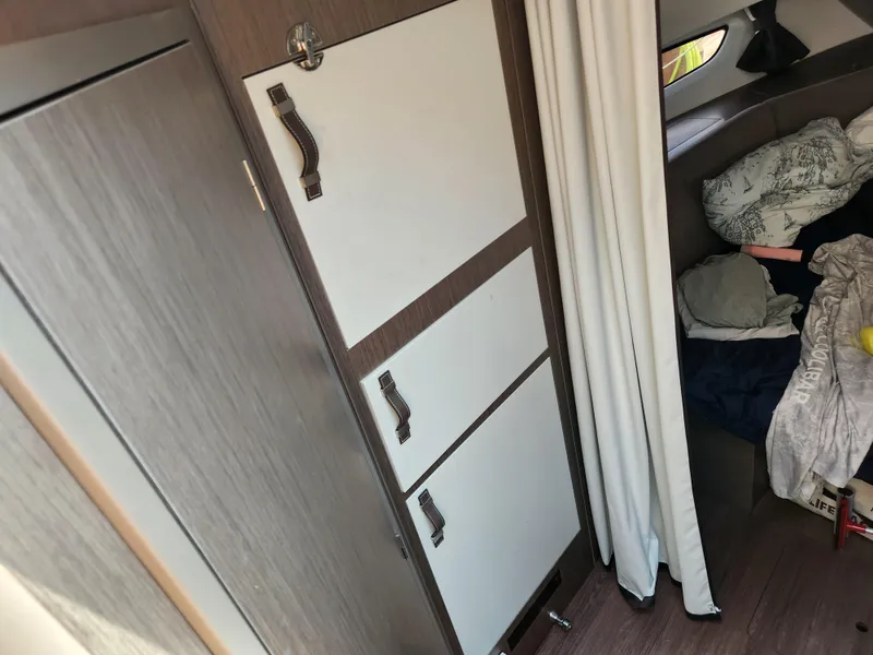 Slide: The Image of Interior of 2023 Beneteau GT32 boat with storage and sleeping area. - 23