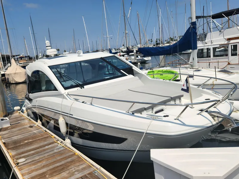 Slide: The Image of 2023 Beneteau GT32 yacht docked at a marina, surrounded by other boats. - 3