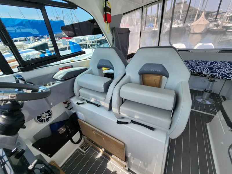 Slide: The Image of 2023 Beneteau GT32 interior with modern seating and sleek design in a marina setting. - 31