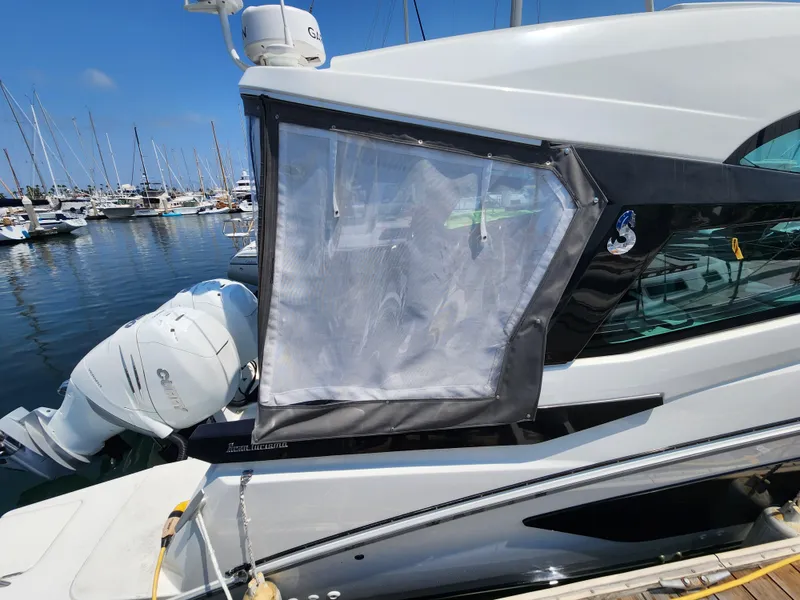 Slide: The Image of 2023 Beneteau GT32 yacht docked at marina with clear window cover. - 5