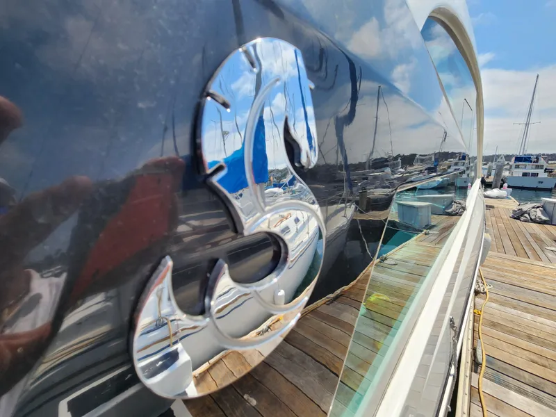 Slide: The Image of Close-up of 2023 Beneteau GT32 yacht logo with marina reflection. - 6