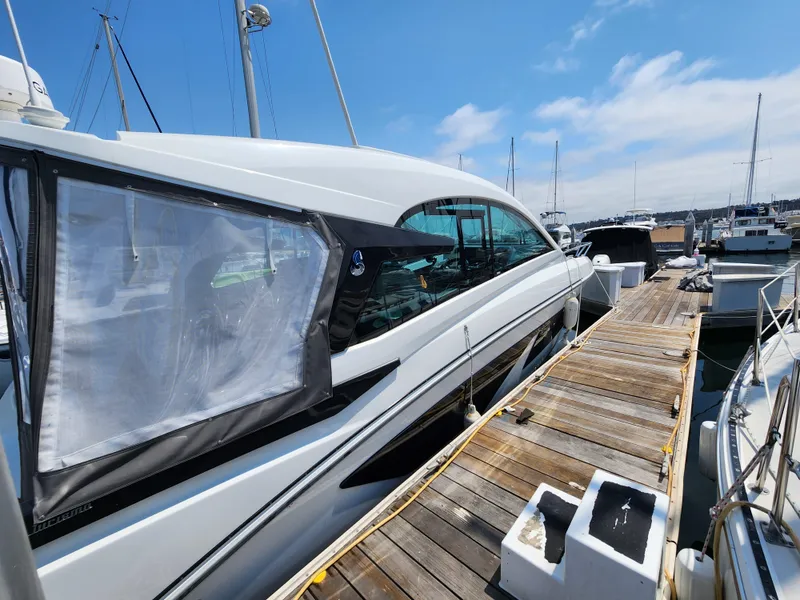 Slide: The Image of 2023 Beneteau GT32 yacht docked at marina under clear blue sky. - 7