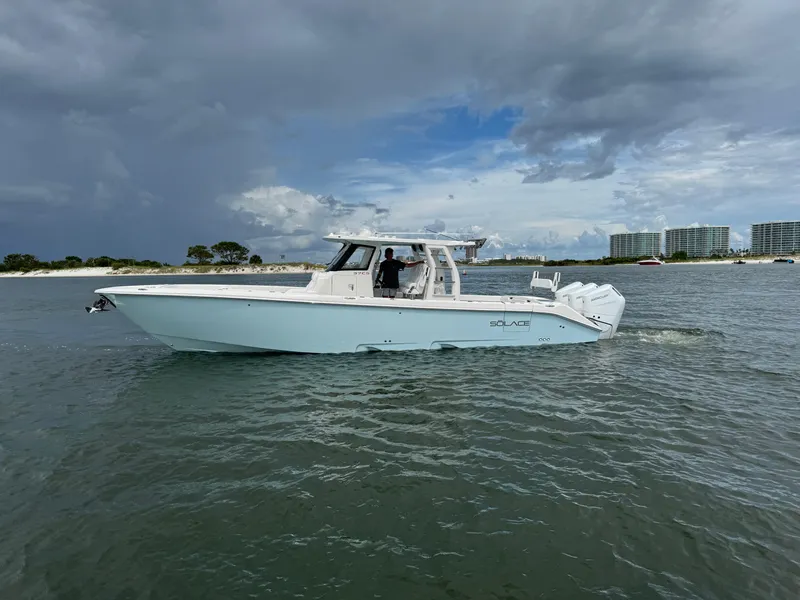 The Image of 2026 Solace 37 CS boat cruising on water under cloudy sky. - 1