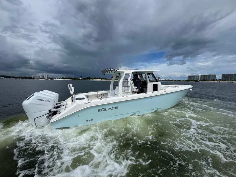 Slide: The Image of 2026 Solace 37 CS boat cruising on water under cloudy sky. - 13