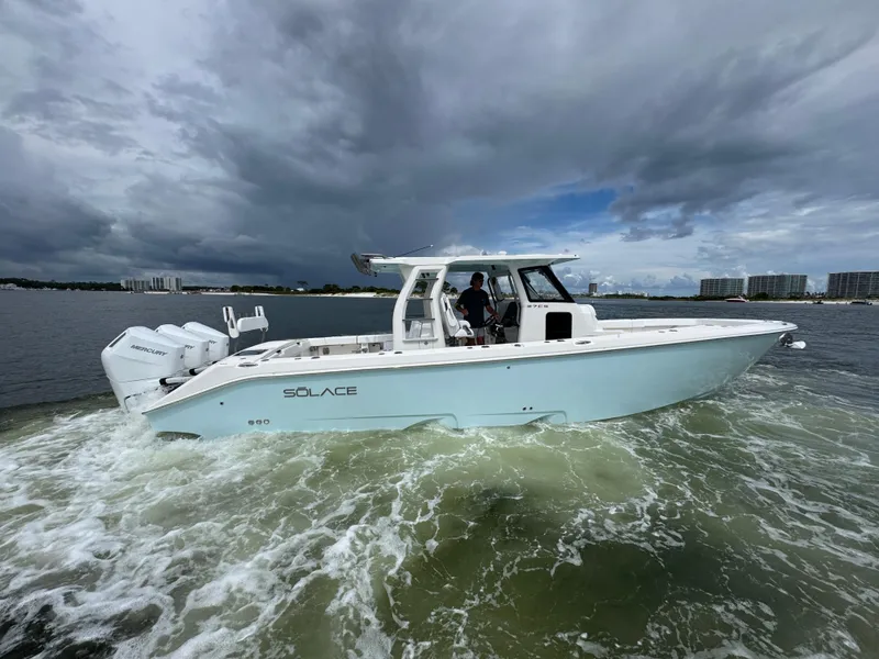 Slide: The Image of 2026 Solace 37 CS boat cruising on water under cloudy skies. - 14