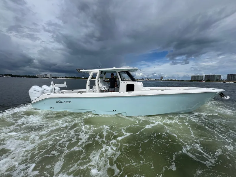 Slide: The Image of 2026 Solace 37 CS boat cruising on water under cloudy sky. - 15