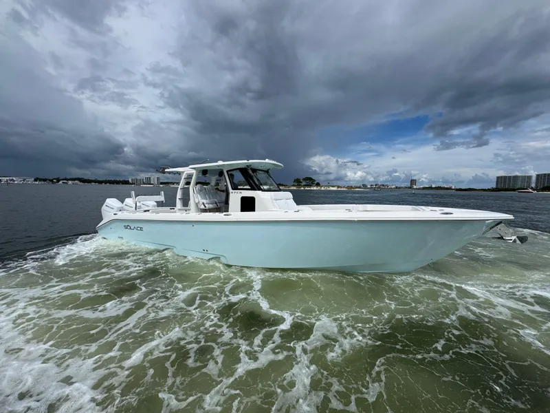 Slide: The Image of 2026 Solace 37 CS boat cruising on a cloudy day in open water. - 16
