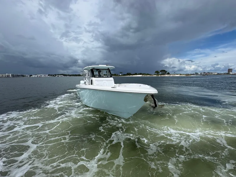 Slide: The Image of 2026 Solace 37 CS boat navigating through calm waters under a cloudy sky. - 17